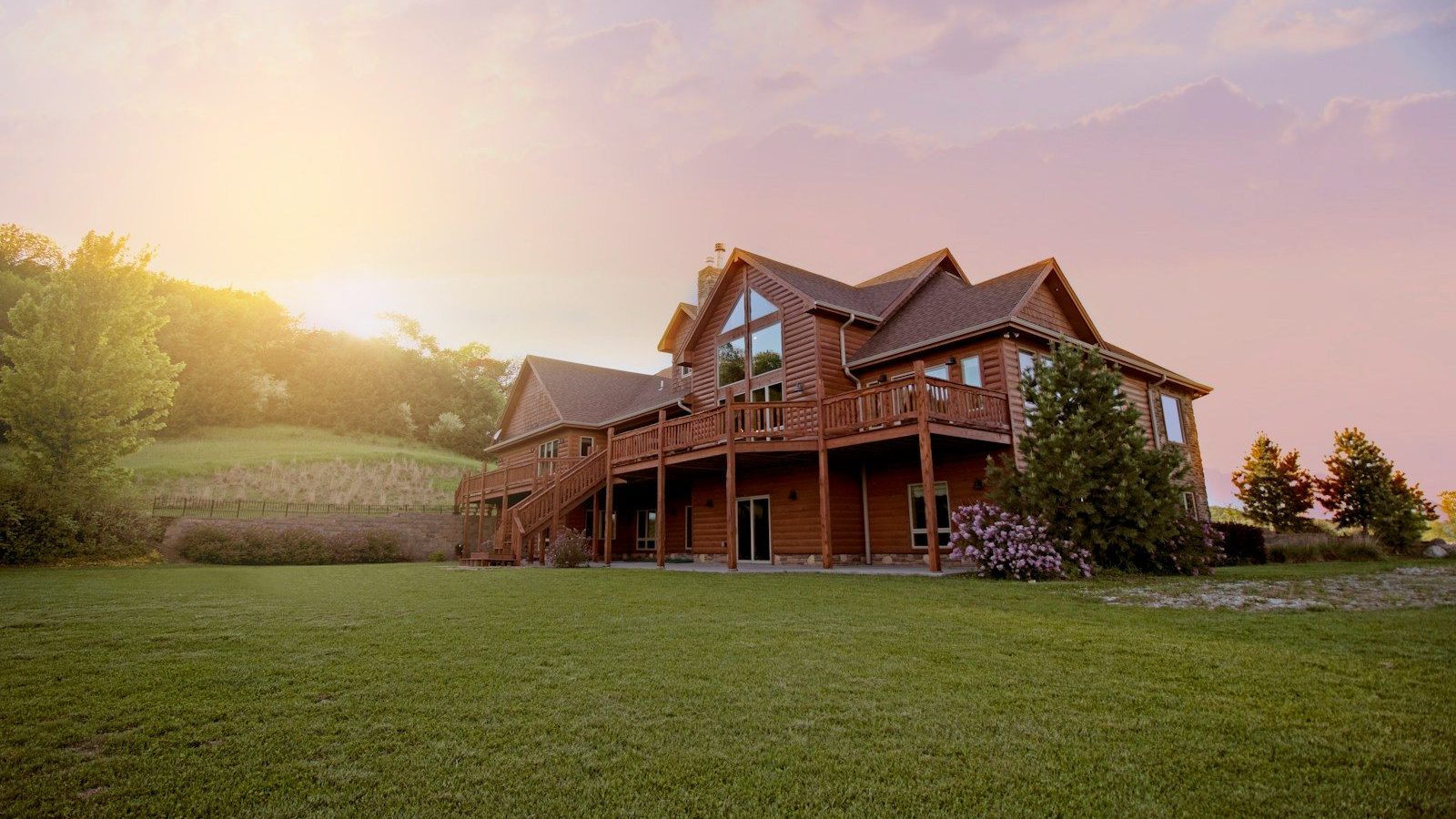 brown wooden house with green grass field